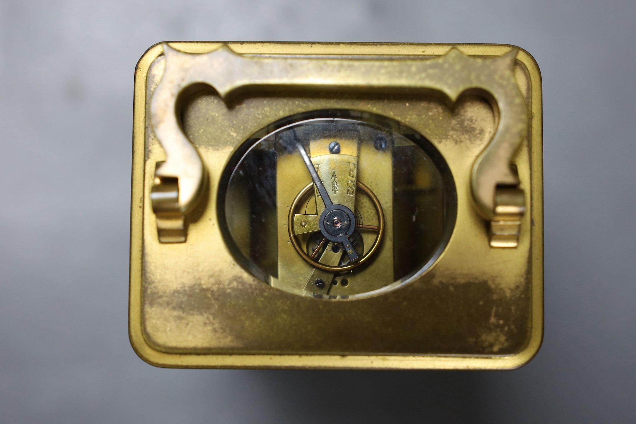 A leather cased brass carriage timepiece. 13cm tall